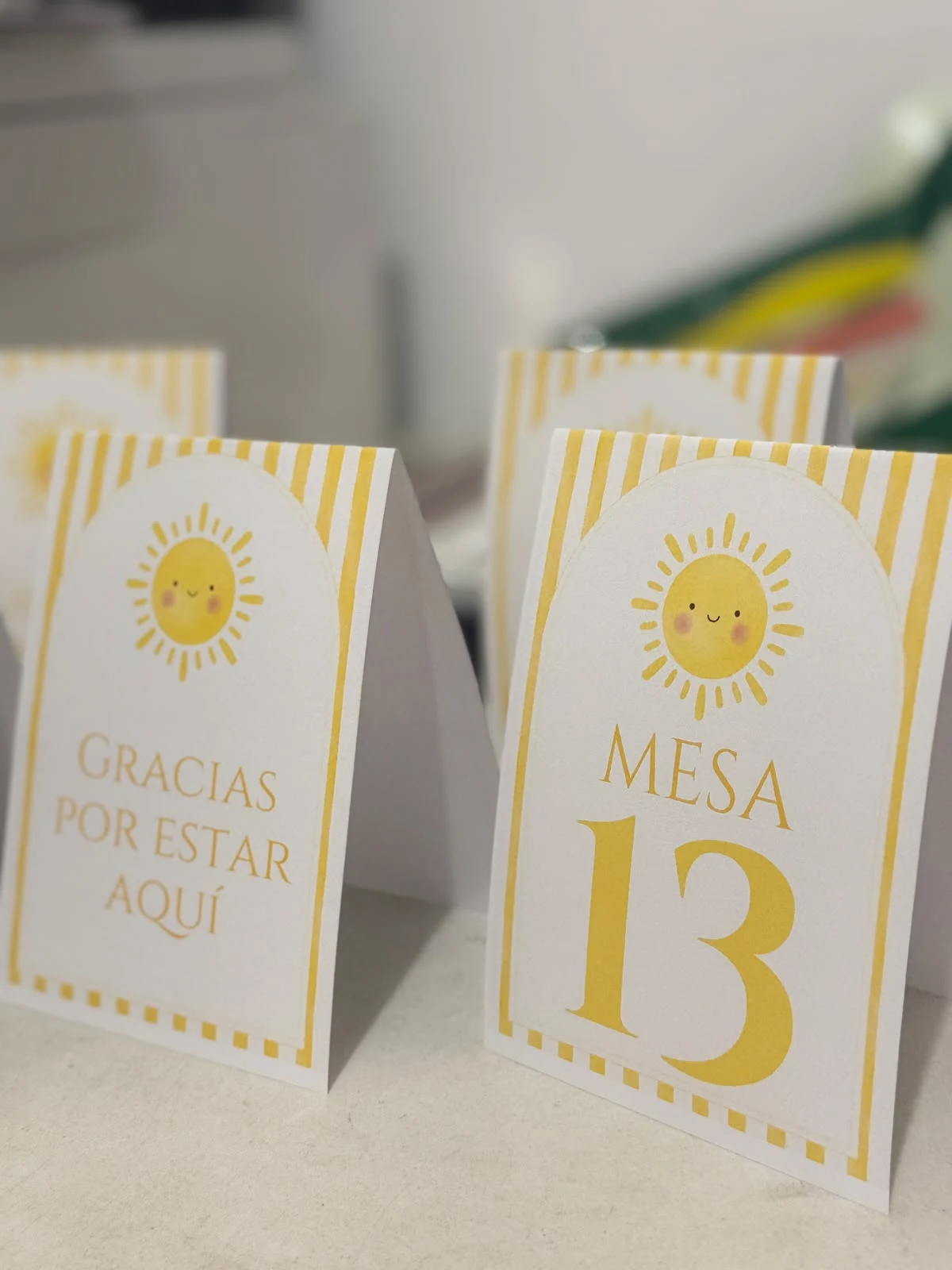 Tarjetas amarillas de agradecimiento y número de mesa con ilustración de sol